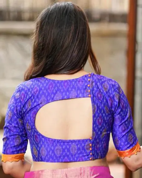 Kanjivaram silk brocade yoke on back cutout blouse with potli buttons